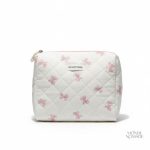 Trousse de toilette en tissu matelassé motifs nœuds papillon