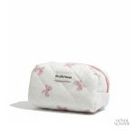 Trousse de toilette motifs nœuds papillon en tissu matelassé