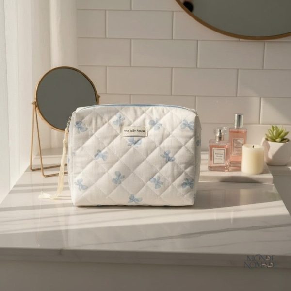 Accessoire de voyage en tissu matelassé motifs nœuds papillon