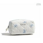 Trousse de toilette pratique en tissu matelassé avec design nœuds