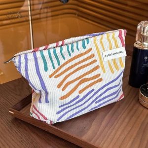Trousse de maquillage rayée en velours coloré